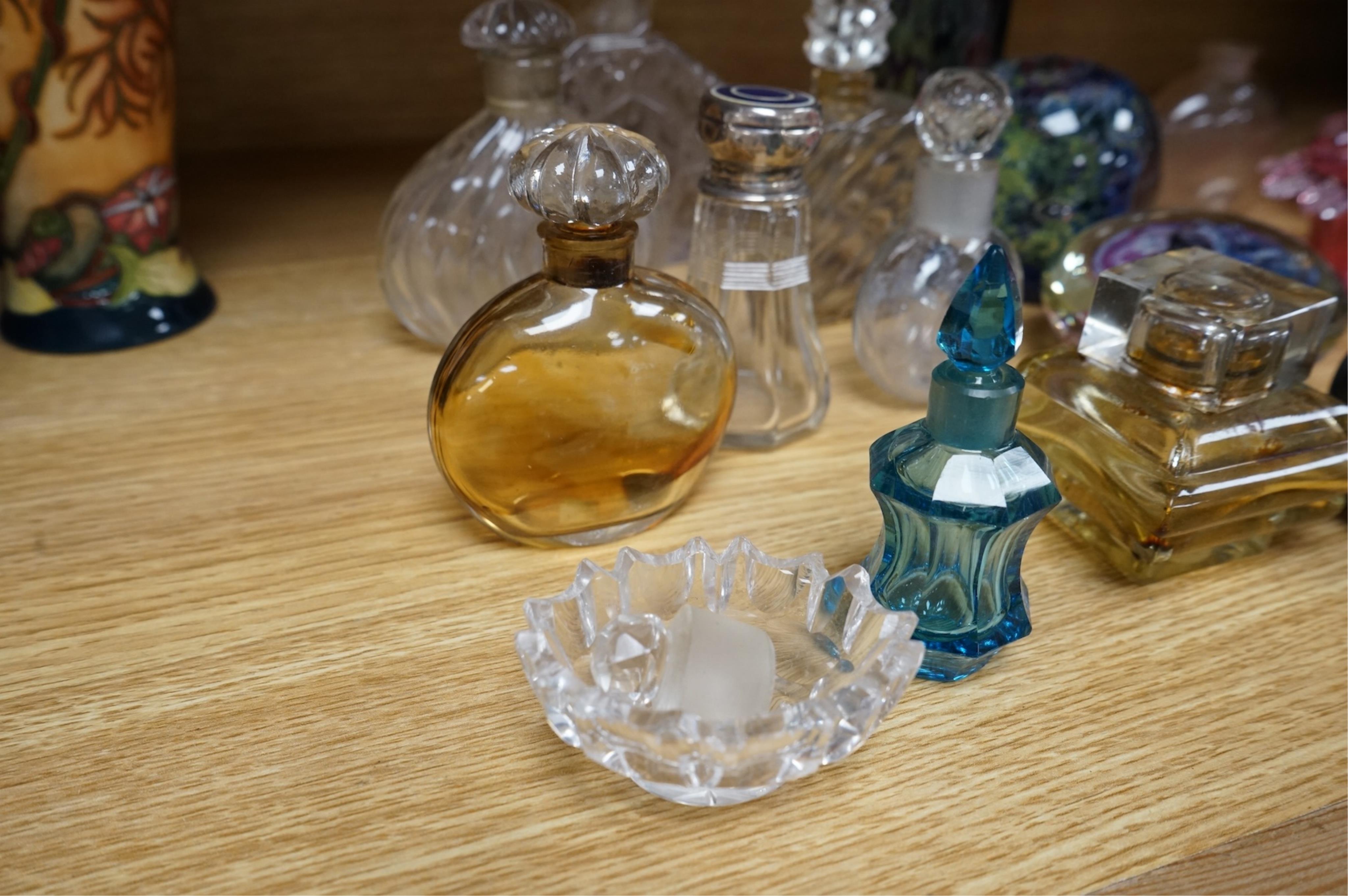 A collection of scent bottles, cranberry glass salts, three glass paperweights and a vase. tallest 18cm high